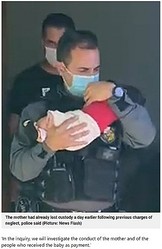 警察官に保護される男児（画像は『Metro　2021年6月12日付「Mum ‘uses two-month-old baby as guarantee on her drug debts’」（Picture: News Flash）』のスクリーンショット）